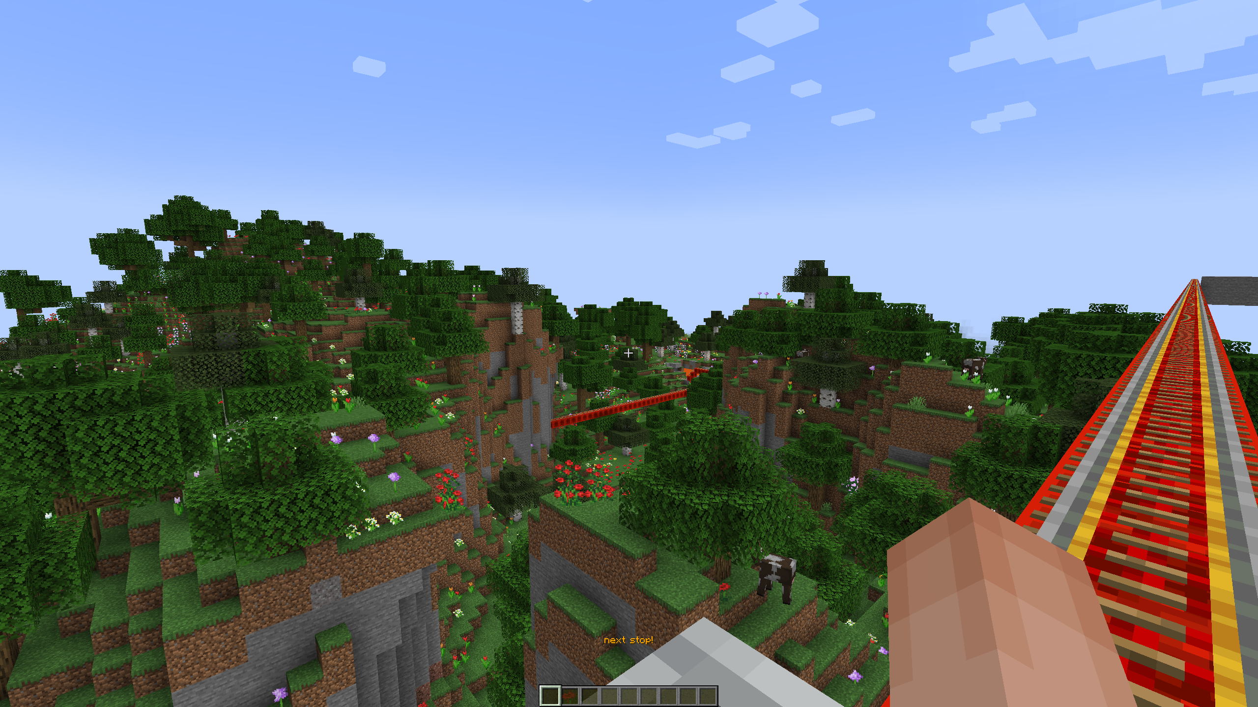 a picture taken while travelling along a minecart track on an automated railway system